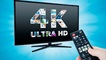 ekran tv z napisem 4K i ręka z pilotem